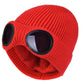 Red knitted beanie with windproof eye shields, close-up
