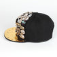 Black baseball cap with gold brim, multicolor rhinestone charms and spike studs