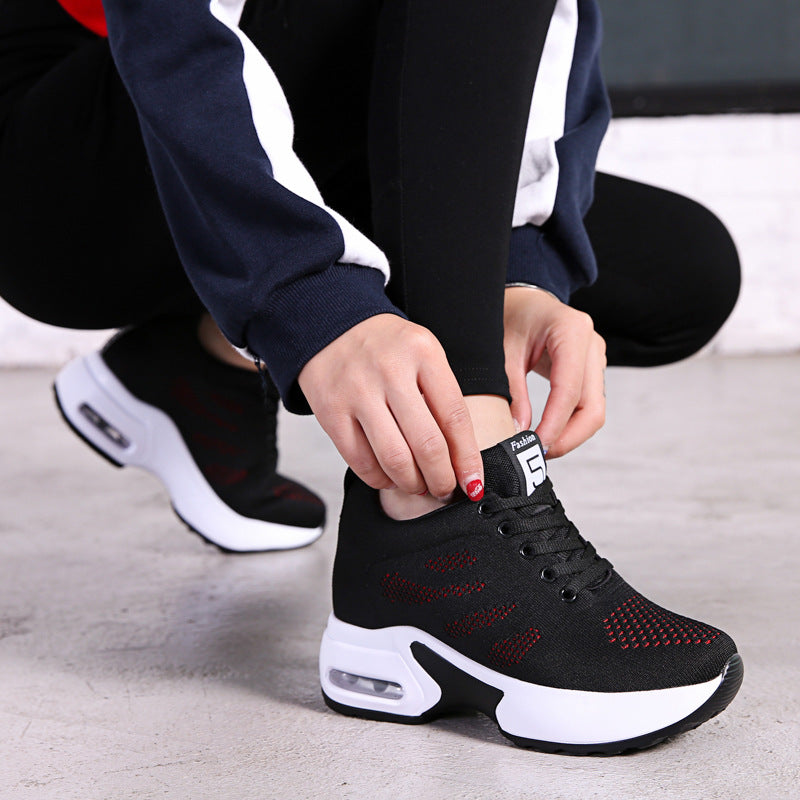 Black knit mesh lace-up sneakers with red speckle detail and white air-cushion sole