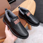 Fleece-lined waterproof slip-on shoes, black leather pair with thick rubber sole