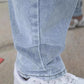 Light blue denim jeans cuff with creased wash and visible hem stitching