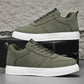Olive green sneakers with white sole and lace-up front